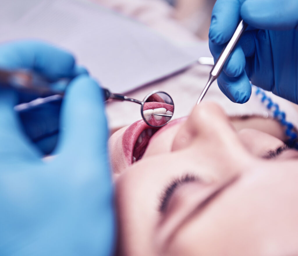 advanced medicine, trusted care. attractive woman at the dental office. dentist examining patient's teeth in clinic.